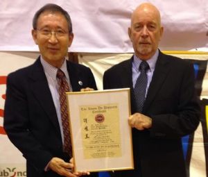 BTC Chairman Dave Oliver receiving his promotion certificate to promote him to 9th Dan Grand Master from Grandmaster C.K. Choi, 9th Dan. The award was made by: Grandmaster CK Choi, Grandmaster J. C. Kim, Grandmaster Sang Min Cho and Grandmaster Woo Yup Yang, all original tae kwon do pioneers.
BTC Chairman Dave Oliver receiving his promotion certificate to promote him to 9th Dan Grand Master from Grandmaster C.K. Choi, 9th Dan. The award was made by: Grandmaster CK Choi, Grandmaster J. C. Kim, Grandmaster Sang Min Cho and Grandmaster Woo Yup Yang, all original tae kwon do pioneers.